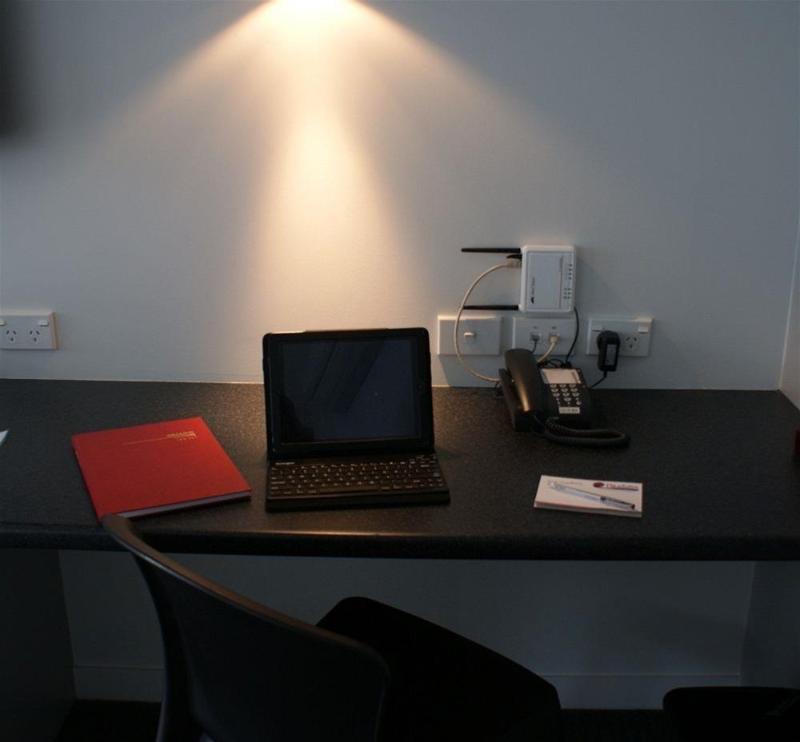 Pukekura Motor Lodge New Plymouth Kültér fotó A typical hotel room with a phone, a laptop and a book